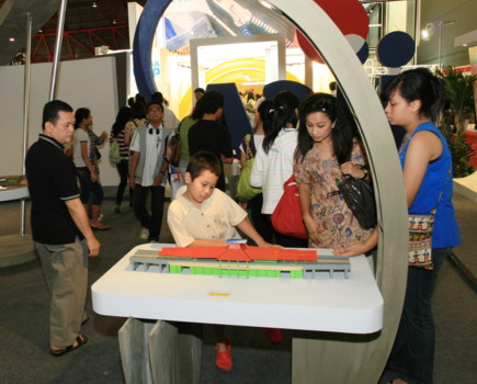 Fig.6 Visitors observing the scaled models of various project outputs
